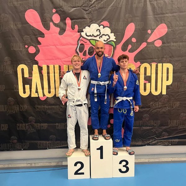 Student on the competition podium with a silver medal